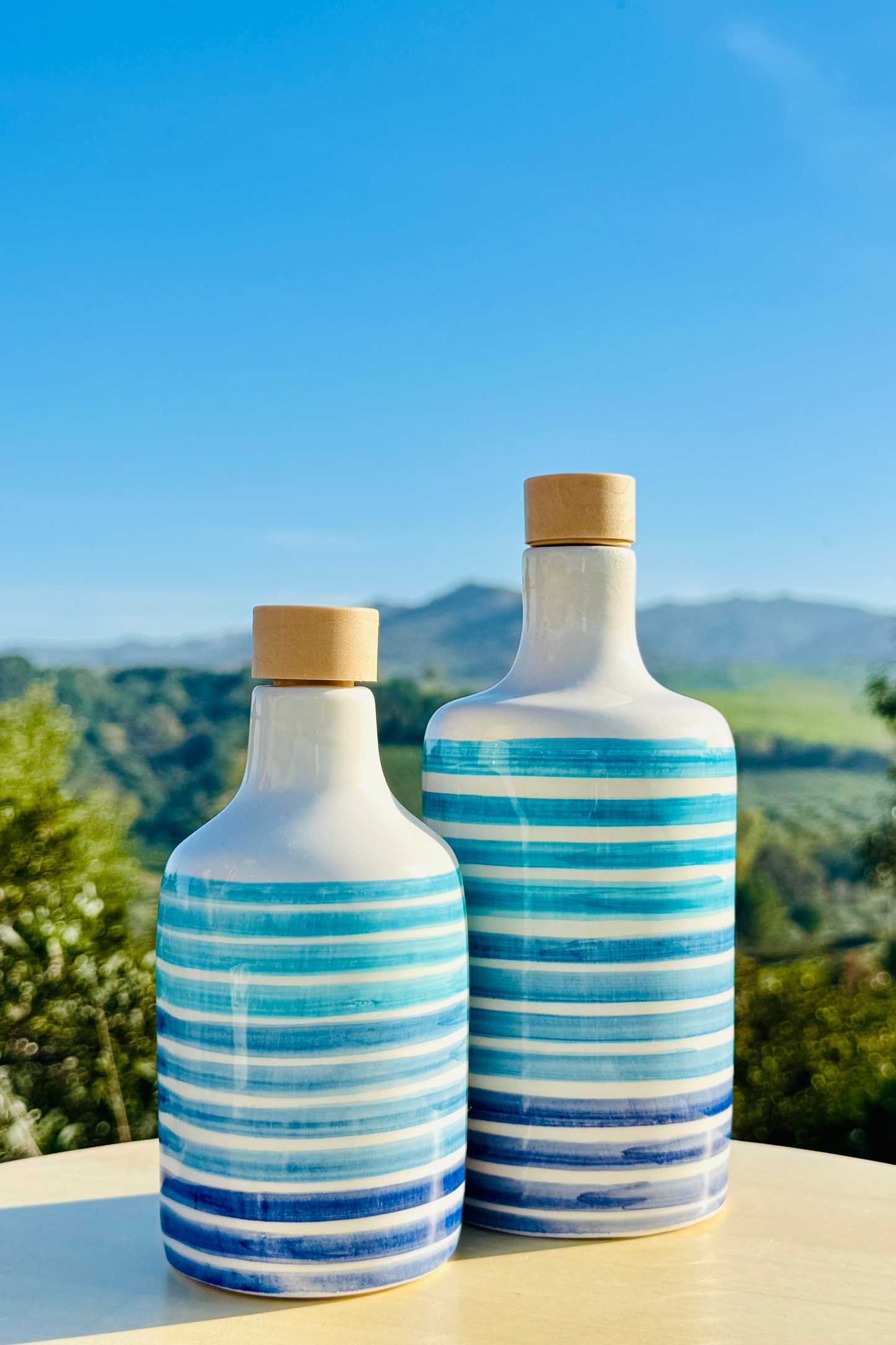 Ceramic bottle oil dispenser with blue lines for olive oil handmade in Italy