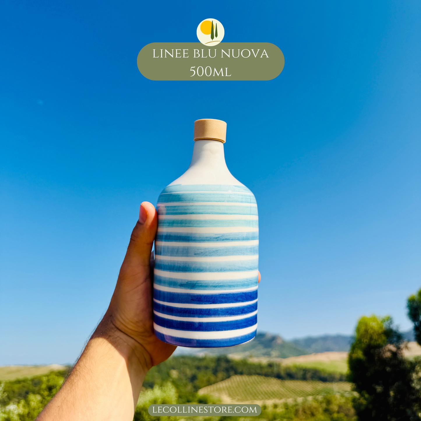 Large blue striped ceramic bottle with hand-painted decoration and cork stopper, held in hand ideal for Mediterranean home decor.