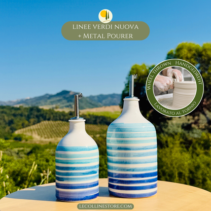 Pair of handcrafted blue ceramic oil bottles with stainless steel pourers and Mediterranean design.