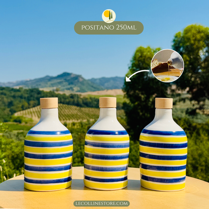 Three small blue and yellow striped ceramic bottles with glossy finish and handcrafted Mediterranean character.