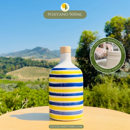 Large ceramic bottle with alternating blue and yellow stripes and glossy handcrafted finish, displayed outdoors.