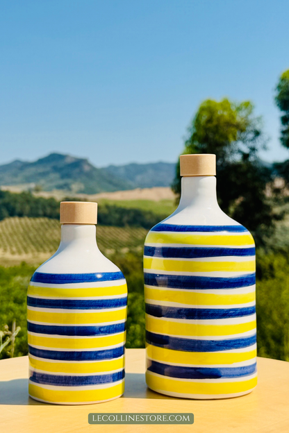 Pair of handcrafted blue and yellow striped ceramic bottles with Mediterranean-inspired design and cork stoppers.