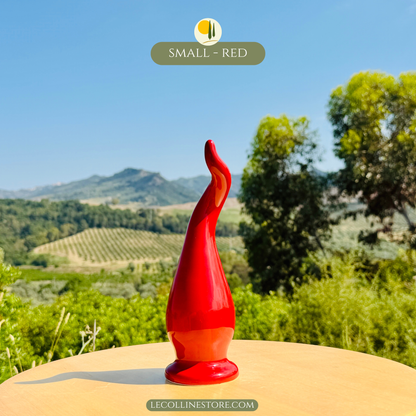 Small handcrafted ceramic lucky horn featuring a vibrant glossy red glaze and elegant curved silhouette. Decorative Italian accent piece suitable for shelf decor, tabletop displays and modern interiors.